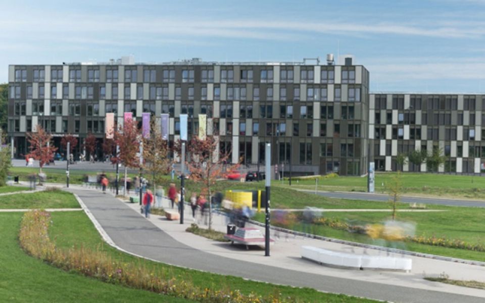 Hochschule Bielefeld mit großer Grünanlage im Vordergrund
